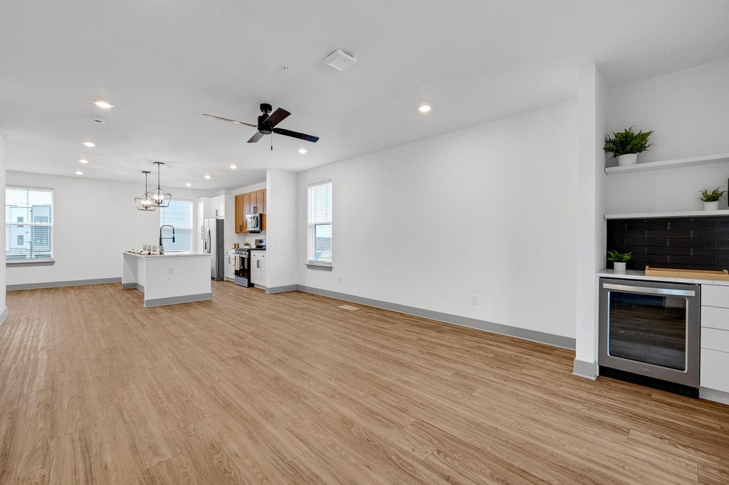 a large room with a wooden floor and a clock on the wall at Meridian at CityPlace, Woodbury, 55125