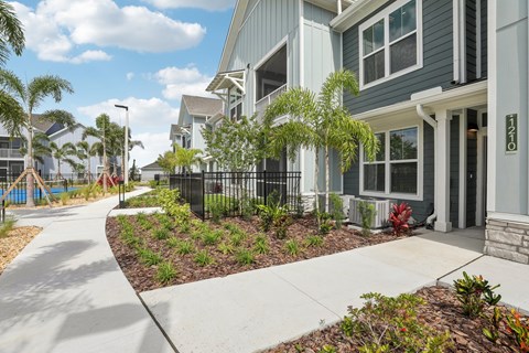 A row of houses with a sidewalk in front. at The Junction at Rockledge Apartments, Rockledge, FL