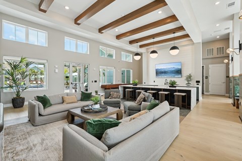 A spacious living room with a large grey sofa and a coffee table.