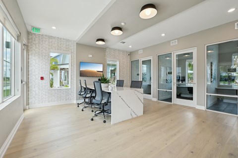 A room with a desk, chairs, and a television at The Junction at Rockledge Apartments, Rockledge, Florida