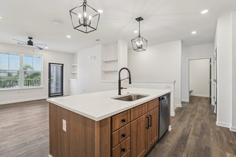 A kitchen with a white countertop and wooden cabinets. at The Junction at Rockledge Apartments, Florida, 32955