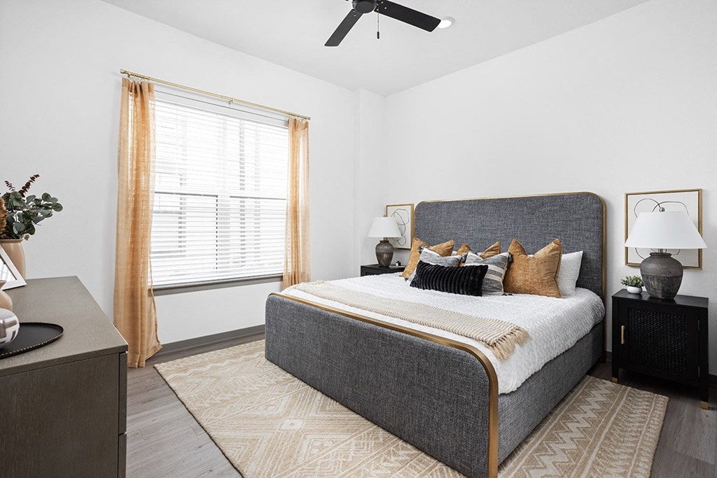 a bedroom with a bed and a ceiling fan