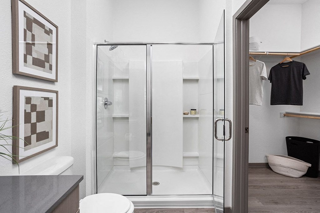 a shower with a glass door in a bathroom