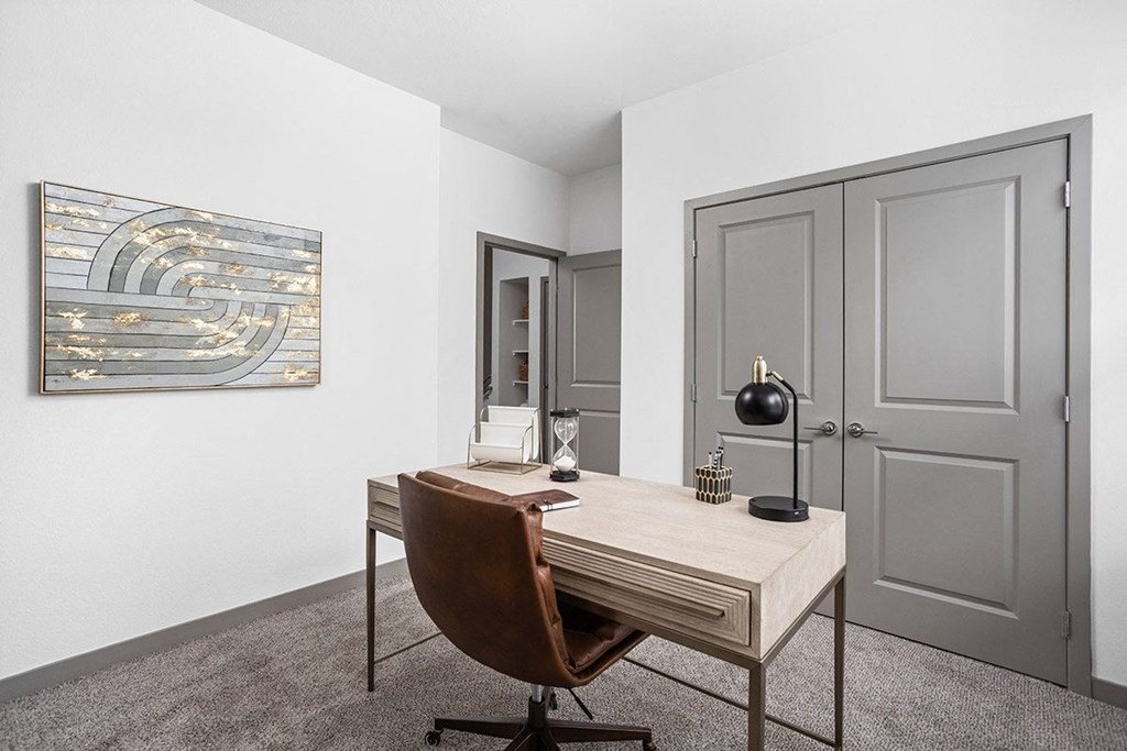 a home office with a desk and a chair