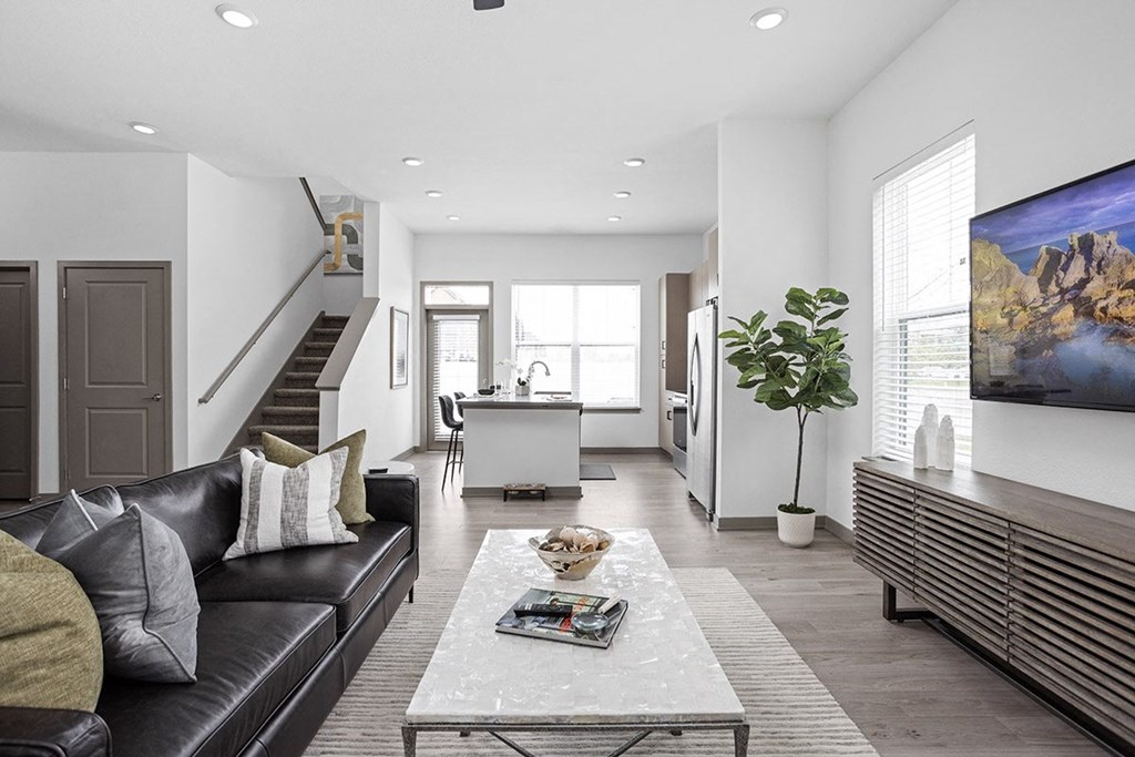 a living room with a leather couch and a coffee table