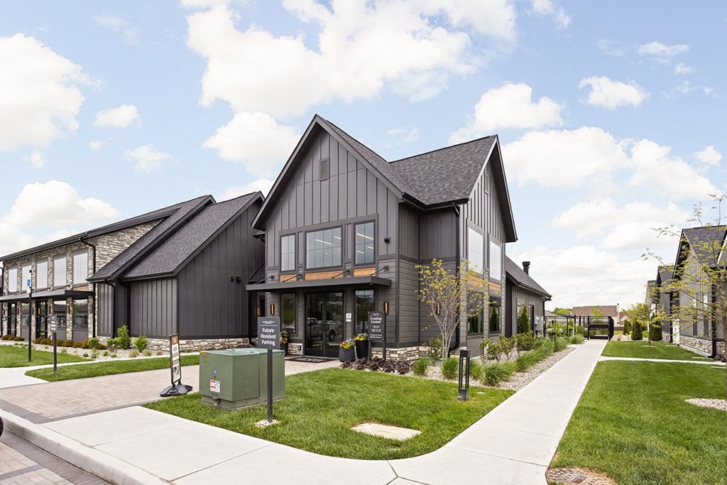 the exterior of a building with a sidewalk and grass