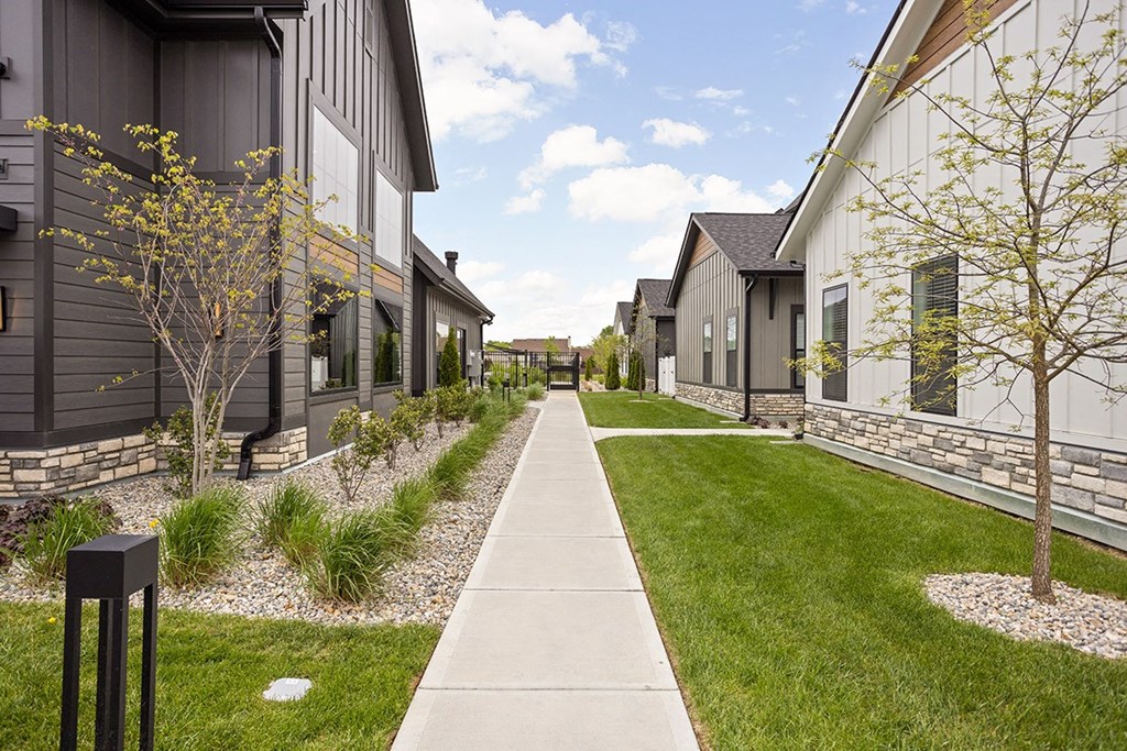 a sidewalk leading to a row of houses