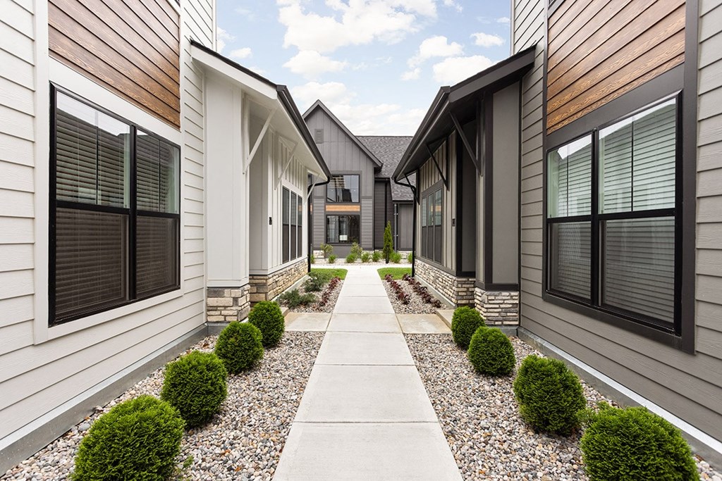 a row of houses with a sidewalk in front of them