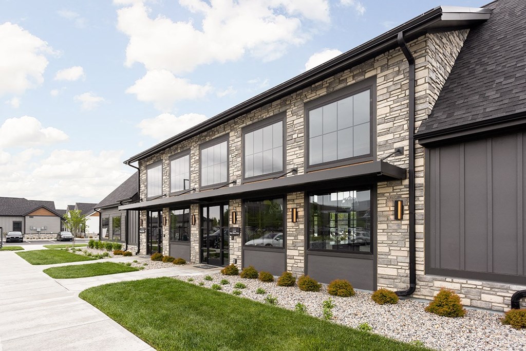the exterior of a house with a sidewalk and grass