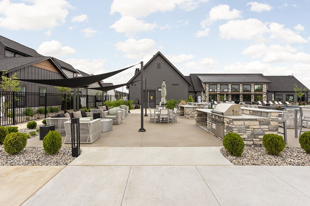 a courtyard with tables and chairs and a building in the background