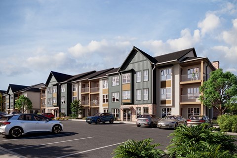 a rendering of an apartment building with cars in a parking lot at Premier at West Park, Greeley Colorado