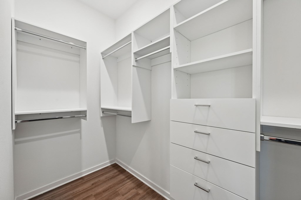 A white closet with drawers and shelves at The Concord Luxury Apartments, Florida