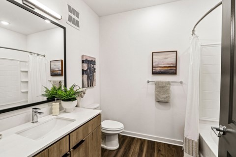 A bathroom with a white sink and toilet.