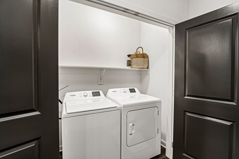 A small laundry room with a washer and dryer.
