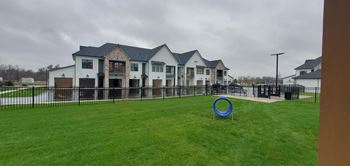 a large yard with a frisbee in front of a house  at The BLVD at Wilson Crossings, Wyoming, MI 49418