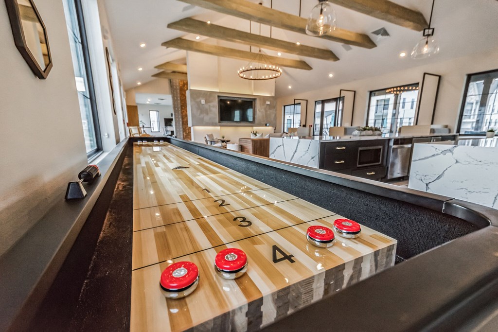 a shuffleboard table in the middle of a game room at The BLVD at Wilson Crossings, Wyoming