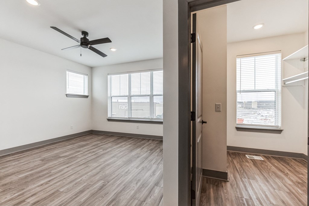 an empty living room with a ceiling fan and a window at Meridian at CityPlace, Minnesota, 55125