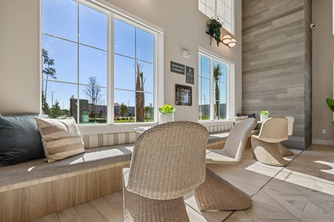 A room with a large window and a view of trees and buildings outside.