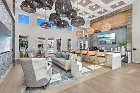 A modern living room with a grey sofa and a wooden floor.