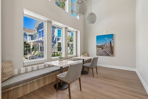 A dining room with a table and chairs.