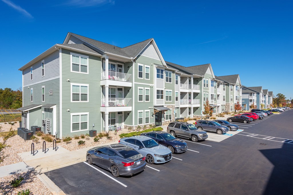an apartment building with cars parked in front of it  at Taylor Farms, North Carolina, 28262