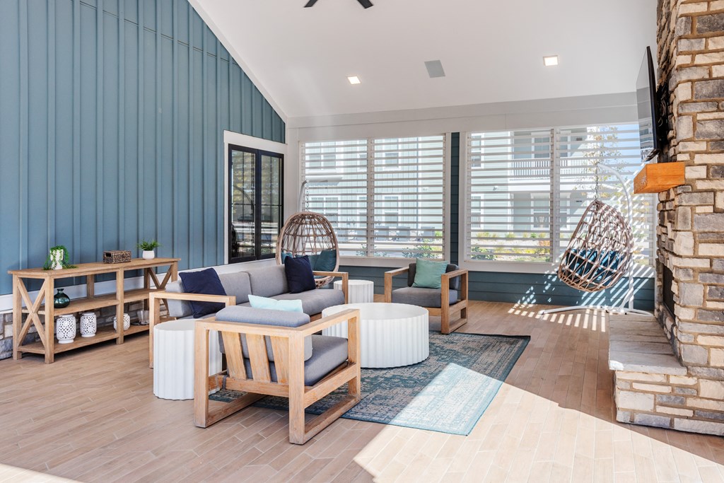a living room with blue walls and a stone fireplace  at Taylor Farms, Charlotte, North Carolina