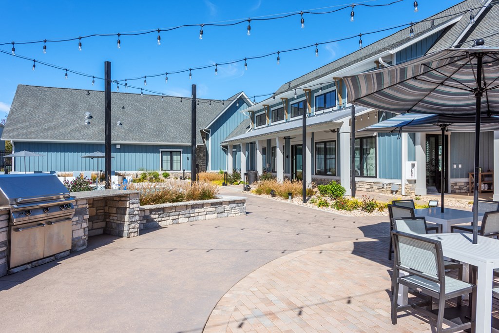 a patio with tables and chairs in front of a building  at Taylor Farms, Charlotte, 28262