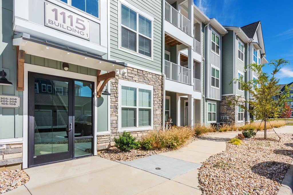 a building with a sidewalk in front of it and a glass door  at Taylor Farms, North Carolina, 28262