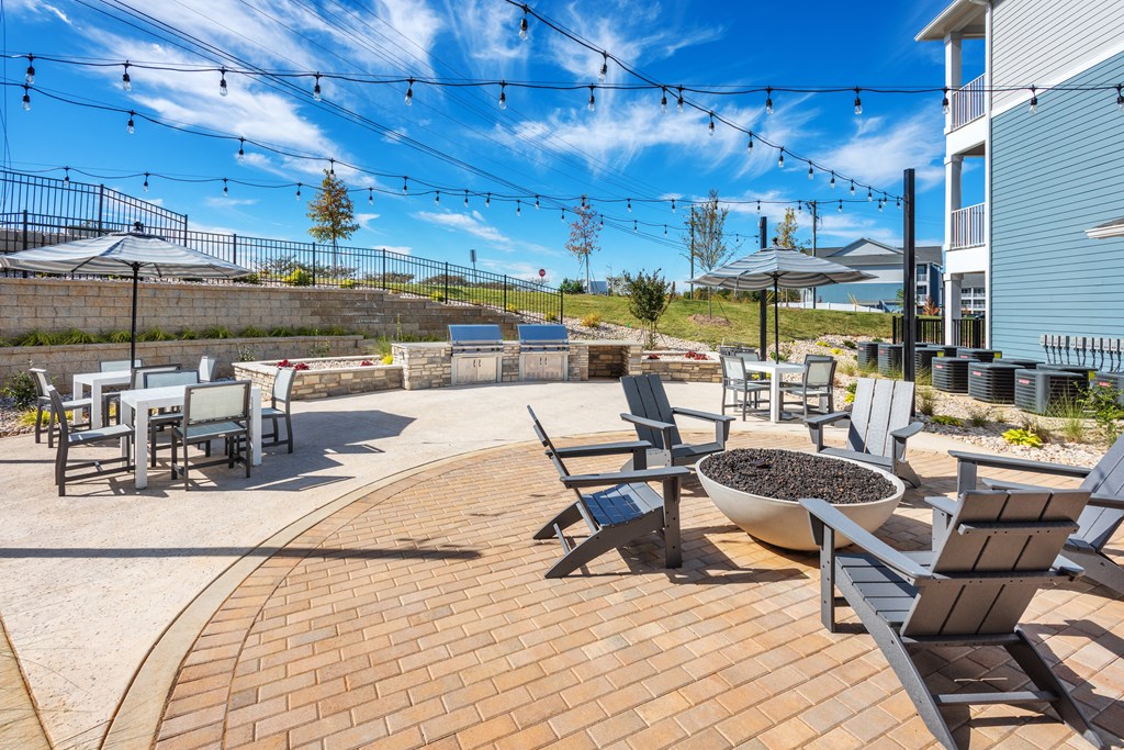 a patio with tables and chairs and a fire pit  at Taylor Farms, Charlotte, NC