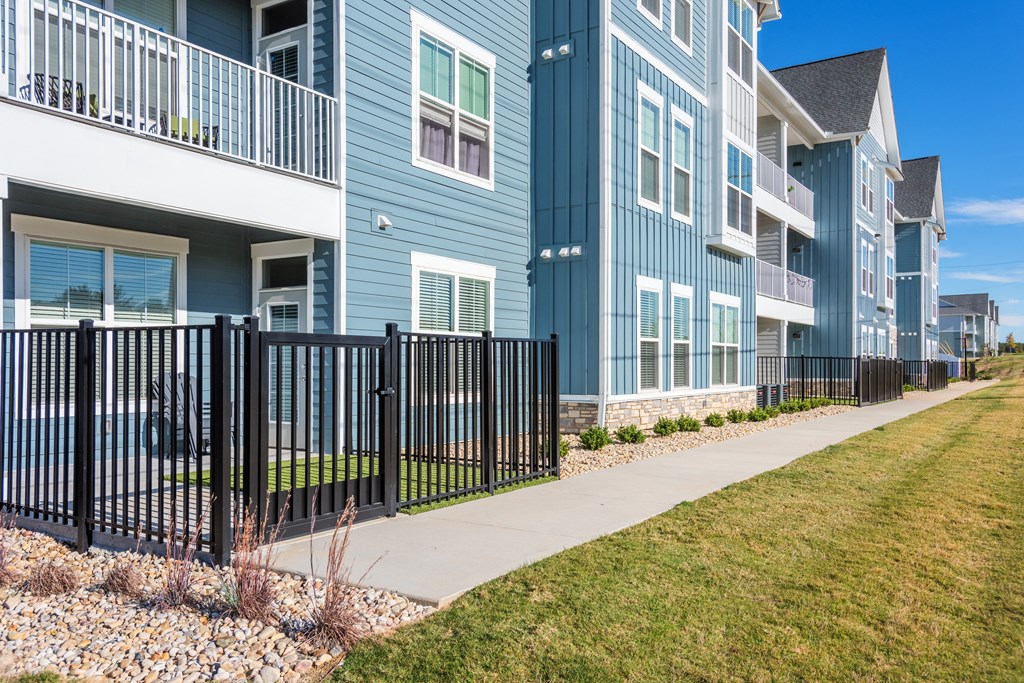 a row of blue houses with a sidewalk and grass  at Taylor Farms, Charlotte, NC
