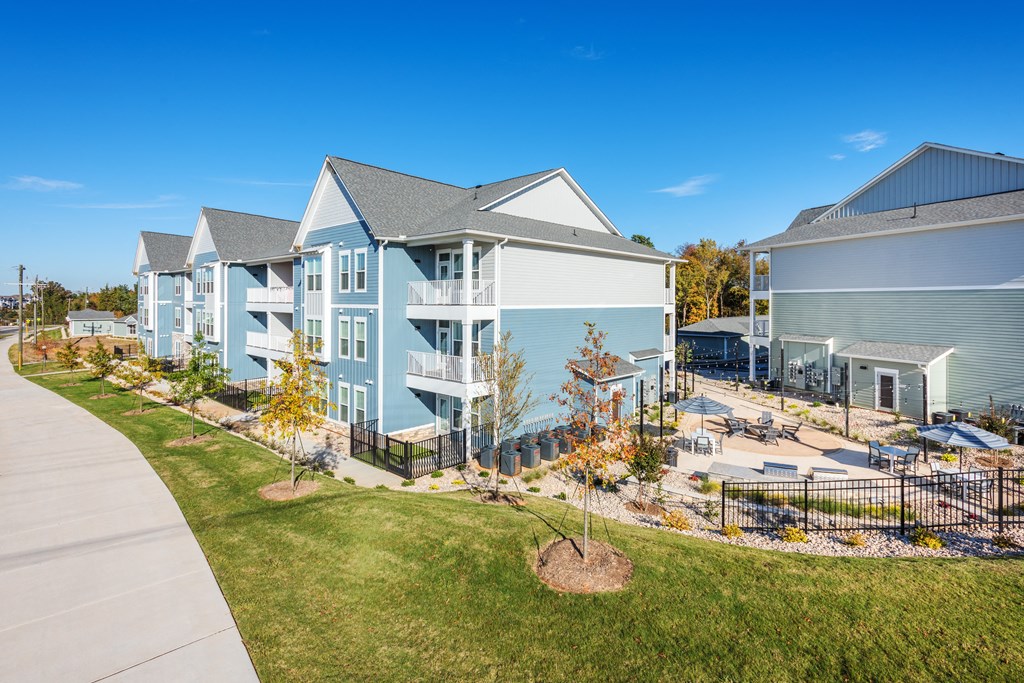 an exterior view of a building with a yard and a sidewalk  at Taylor Farms, Charlotte, NC