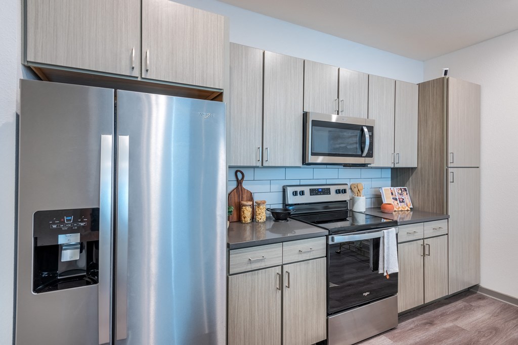 a kitchen with stainless steel appliances and white cabinets  at Taylor Farms, Charlotte, 28262