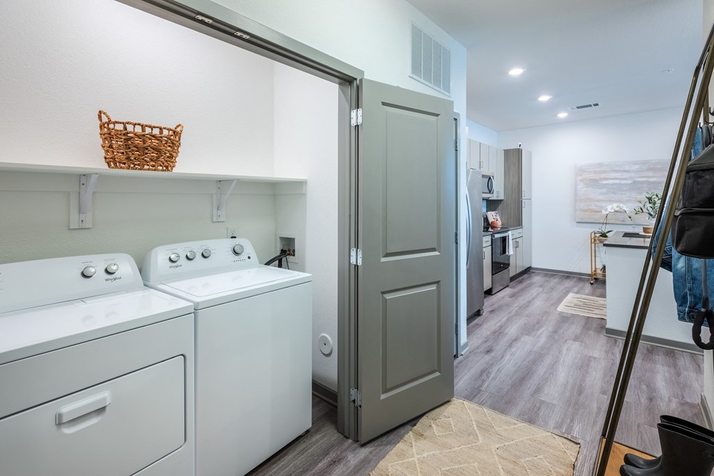 a washer and dryer in a laundry room with a door to a kitchen  at Taylor Farms, Charlotte, NC, 28262