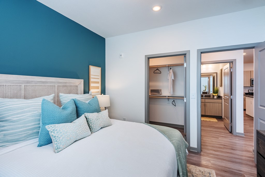 a bedroom with a large bed and a door to a bathroom  at Taylor Farms, Charlotte