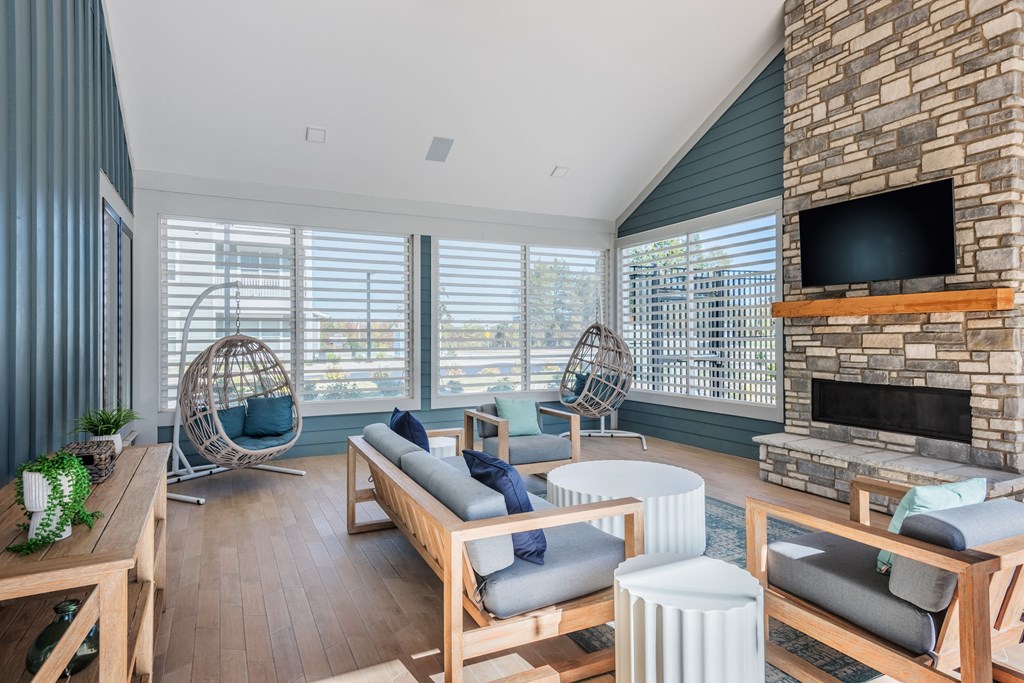 a living room with a large brick fireplace and a television  at Taylor Farms, North Carolina