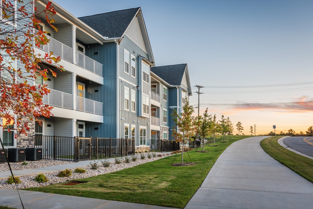 a row of townhomes with a sidewalk in front of them  at Taylor Farms, Charlotte