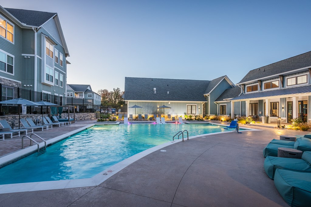a swimming pool in the middle of apartments at dusk  at Taylor Farms, Charlotte, NC, 28262