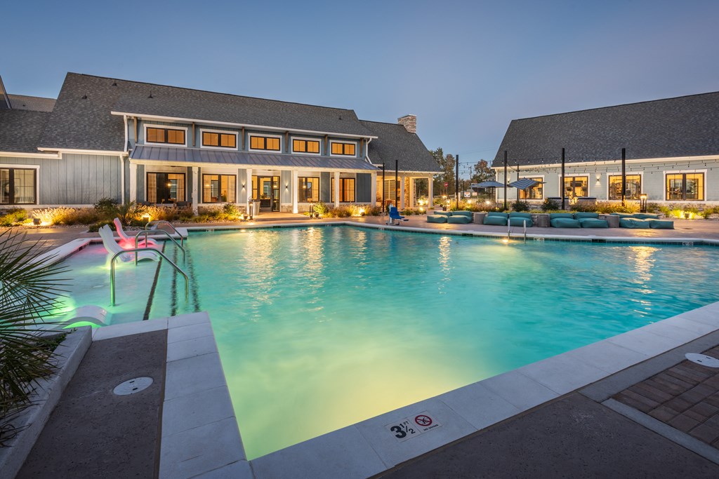 a large swimming pool with a house in the background  at Taylor Farms, Charlotte, North Carolina