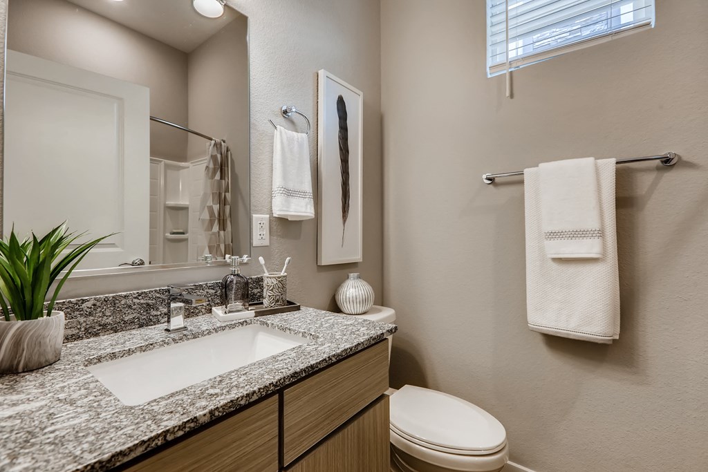 a bathroom with three sinks and three mirrors in it  at Grandstone at Sunrise, Arizona, 85383