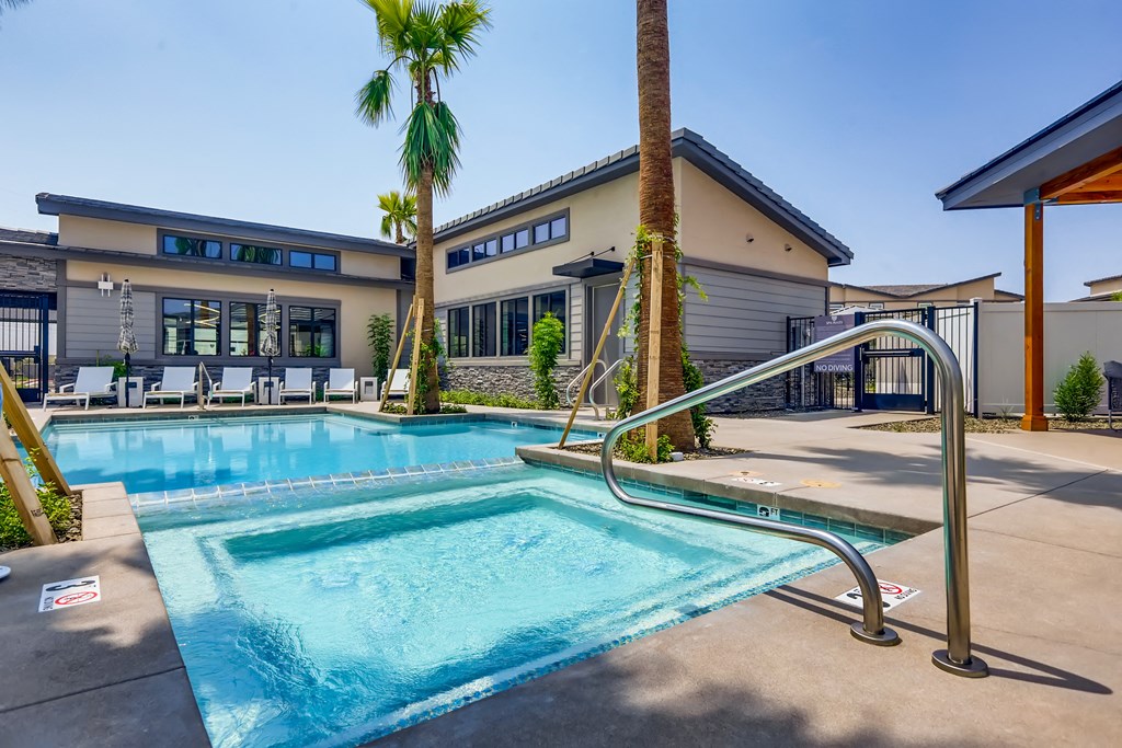 a swimming pool with a building in the background at Grandstone at Sunrise, Peoria