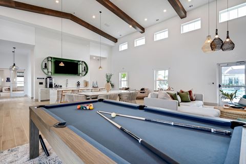 an open living room with a pool table and a tv