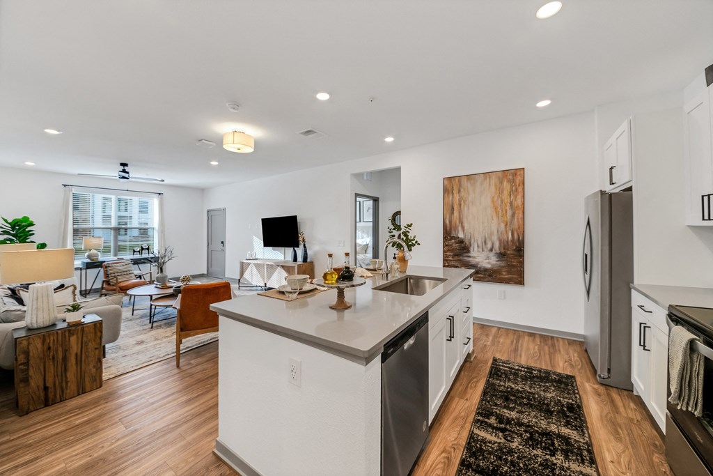 an open living room and kitchen with a dining area and a living room at The BLVD at Wilson Crossings, Wyoming, Michigan