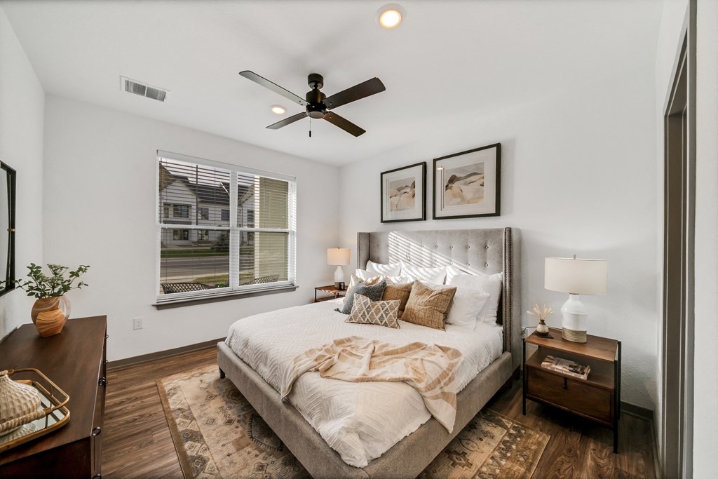 a bedroom with a large bed and a ceiling fan at The BLVD at Wilson Crossings, Wyoming