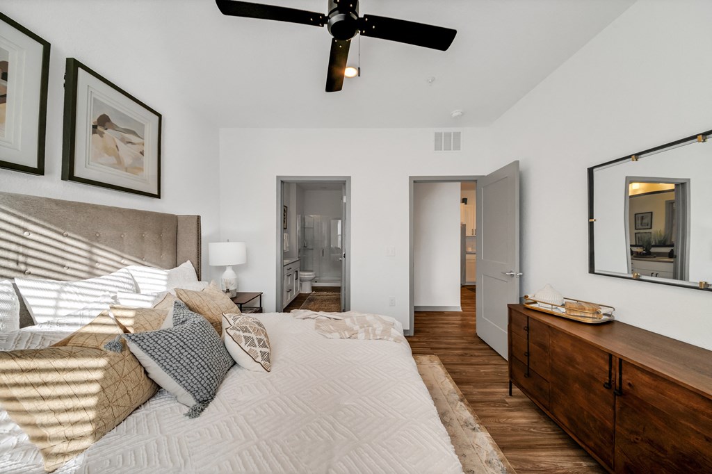 a bedroom with a large bed and a ceiling fan at The BLVD at Wilson Crossings, Wyoming, Michigan