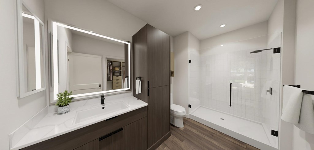 A modern bathroom with a white sink and a large mirror at Switch Luxury Living in Colorado Springs, CO