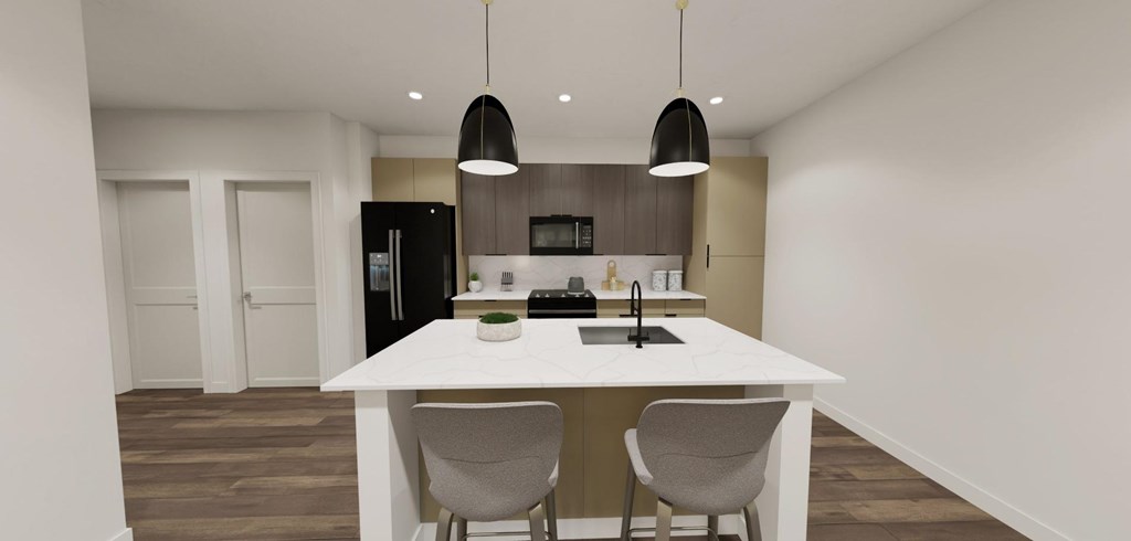 A modern kitchen with a white island and two grey chairs at Switch Luxury Living in Colorado Springs, CO