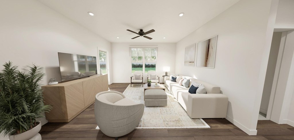 A modern living room with a television, sofas, and a ceiling fan at Switch Luxury Living in Colorado Springs, CO