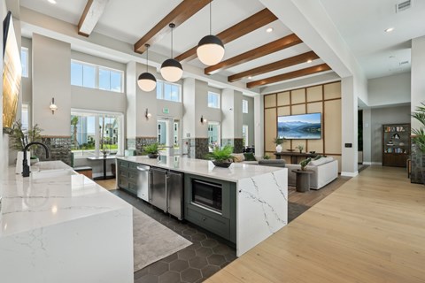 A modern kitchen with a marble countertop and stainless steel appliances. at The Junction at Rockledge Apartments, Florida