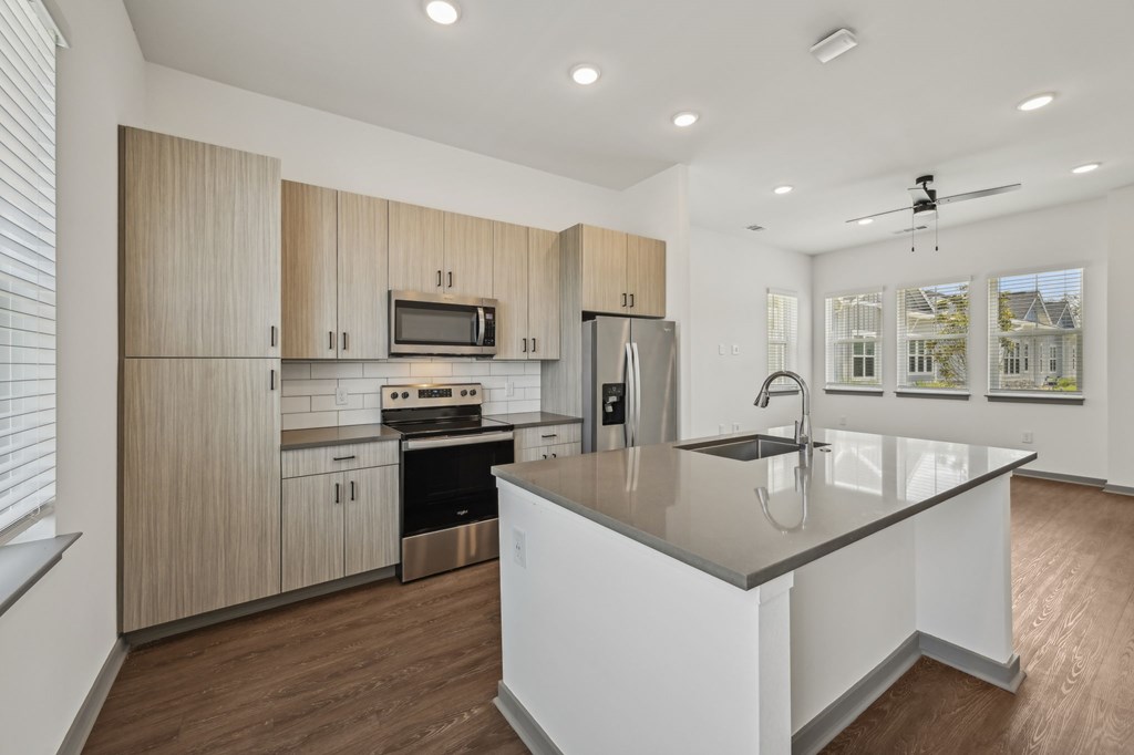 A modern kitchen with a large island and stainless steel appliances. at The Sophia, Venice, FL, 34275