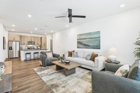 A modern living room with a grey couch and a coffee table. at The Junction at Rockledge Apartments, Rockledge, FL, 32955